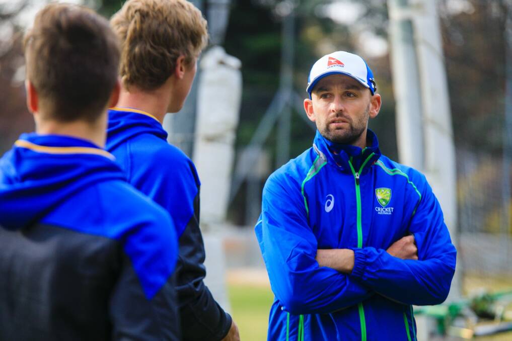 Nathan Lyon gives some advice to Tom Vane-Tempest and Ben Taylor. Photo: Sitthixay Ditthavong