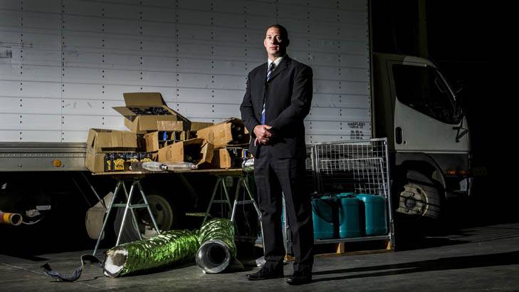 Detective Sergeant Shane Scott with some of the hydroponic equipment found dumped at Kaleen High School. Photo: Rohan Thomson