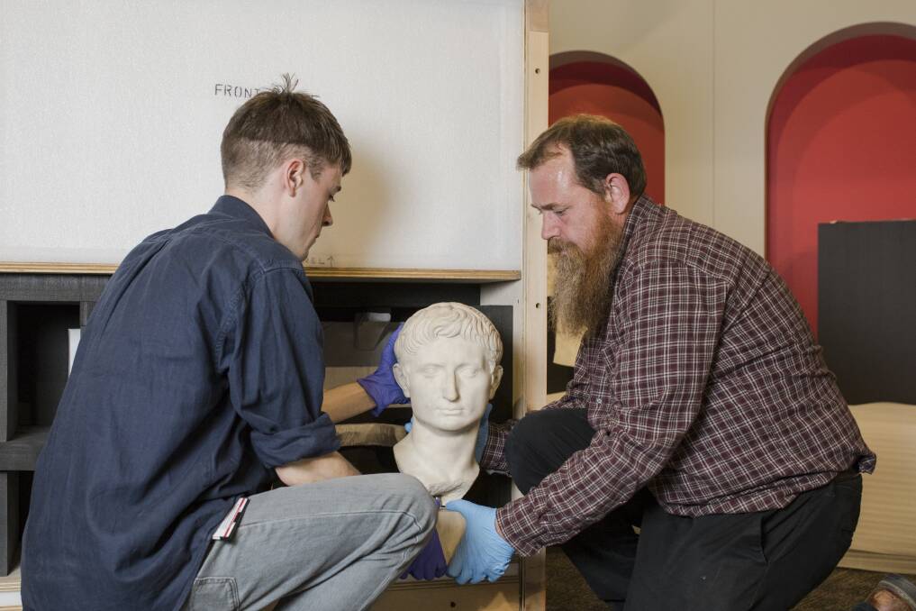 From left, Assistant collections manager, heavy objects Damien Hart, and collections manager, heavy objects Darrel Day both of the British Museum, with the head of Augustus Caesar, Rome's first emperor. Photo: Jamila Toderas