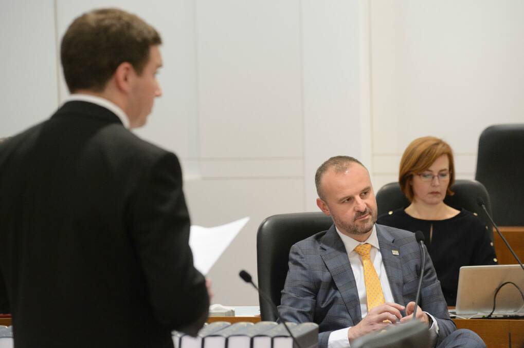 ACT Chief Minister Andrew Barr listens to Opposition leader Alistair Coe during the debate. Photo: Sitthixay Ditthavong