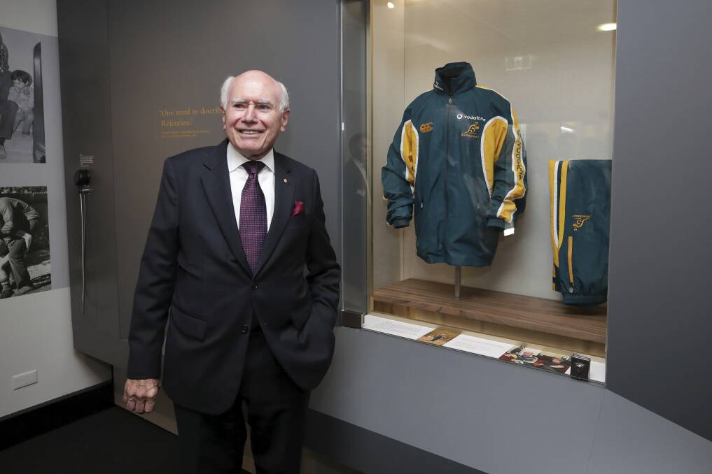 Former Prime Minister John Howard with one of his old tracksuits during the opening of the UNSW Howard Library at Old Parliament House in Canberra on Tuesday 4 December 2018. Photo:  Alex Ellinghausen
