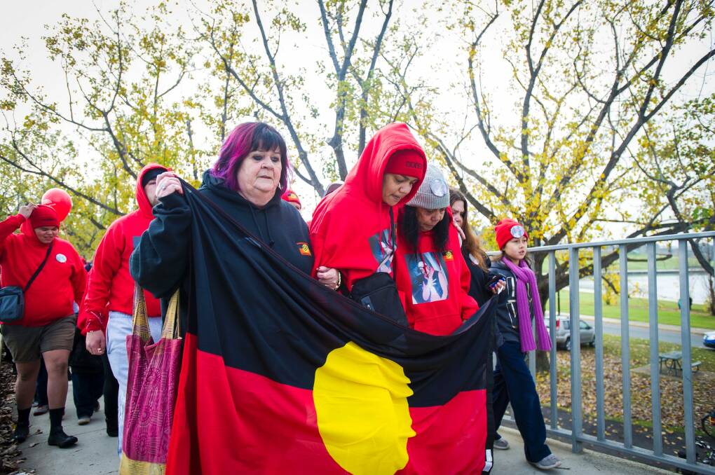 Julie Tongs of Winnunga Nimmityjah (left, holding flag) taking part in the Sorry Day bridge walk in memory of Steven Freeman, an Aboriginal man who died in custody in the ACT. Photo: Dion Georgopoulos