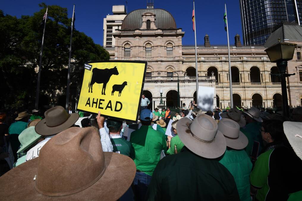 Farmers and their supporters protest outside Parliament House in Brisbane on Tuesday. Photo: AAP