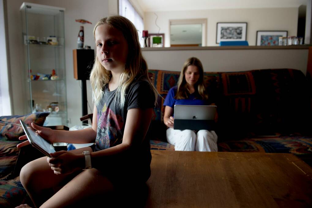 Emma Lucas, 10, with mum Cecilia Shlegal. Cecilia lives with RSI and is worried about how the use of technology by children today will impact on them in the future. Photo: Jay Cronan