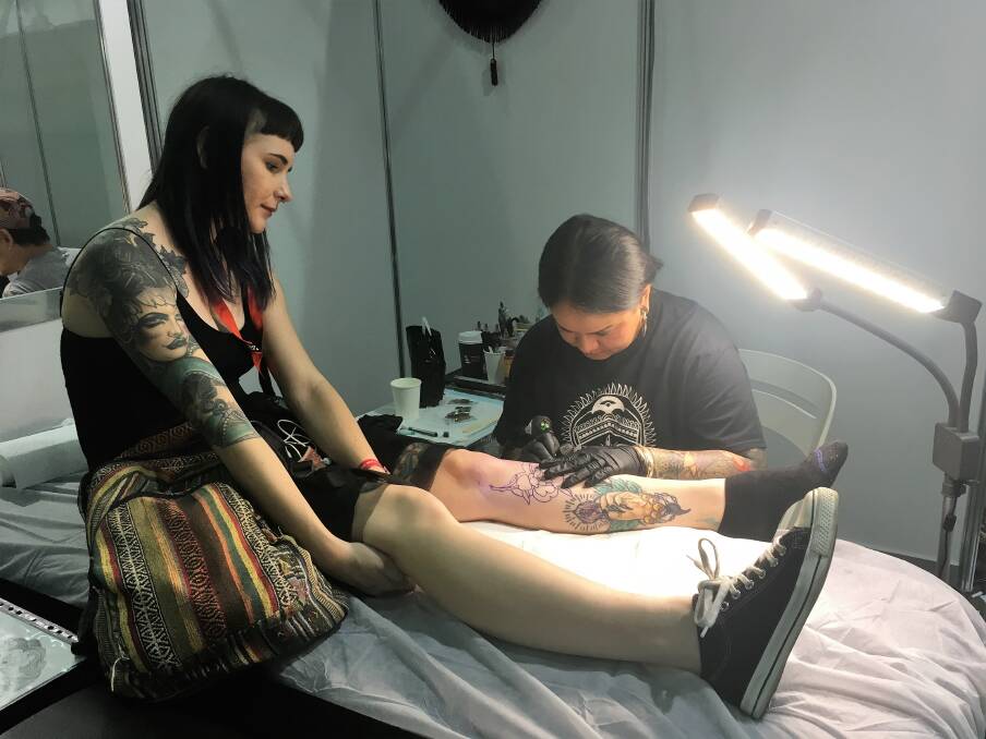 A woman sits for a new tattoo at the Australian Tattoo Expo at the Brisbane Convention Centre on Sunday. Photo: Lucy Stone/Fairfax Media