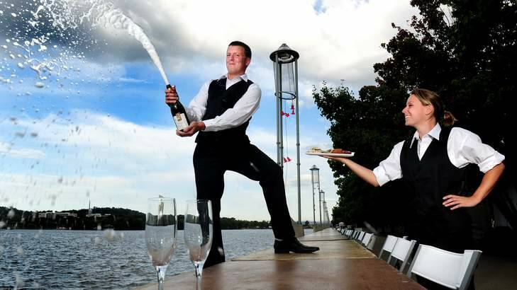 Jack Clarke,27 and Amanda Topham,26 prepare for the Centenary of Canberra's Longest Bubbly Bars in the world located at Commonwealth Place, Canberra. Photo: Melissa Adams