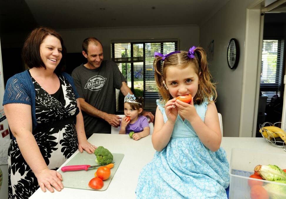 The Harvey family, from left, Ngaire, Chris, Imogen, 3, and Aisha, 5, at home in Kambah. They encourage their children to eat vegetables. Photo: Melissa Adams