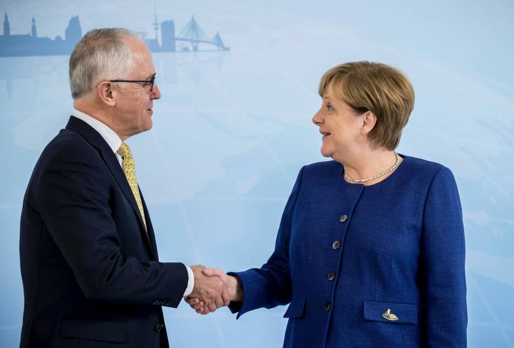 German Chancellor and host of this weekend's G20 meeting Angela Merkel greets Prime Minister Malcolm Turnbull. Photo: AP