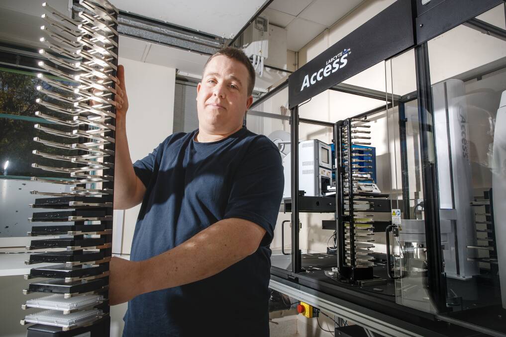 Dr Andreas Zwick unloads the CSIRO's new acoustic liquid handler, which dramatically speeds up its DNA sequencing of insect specimens. Photo: Sitthixay Ditthavong
