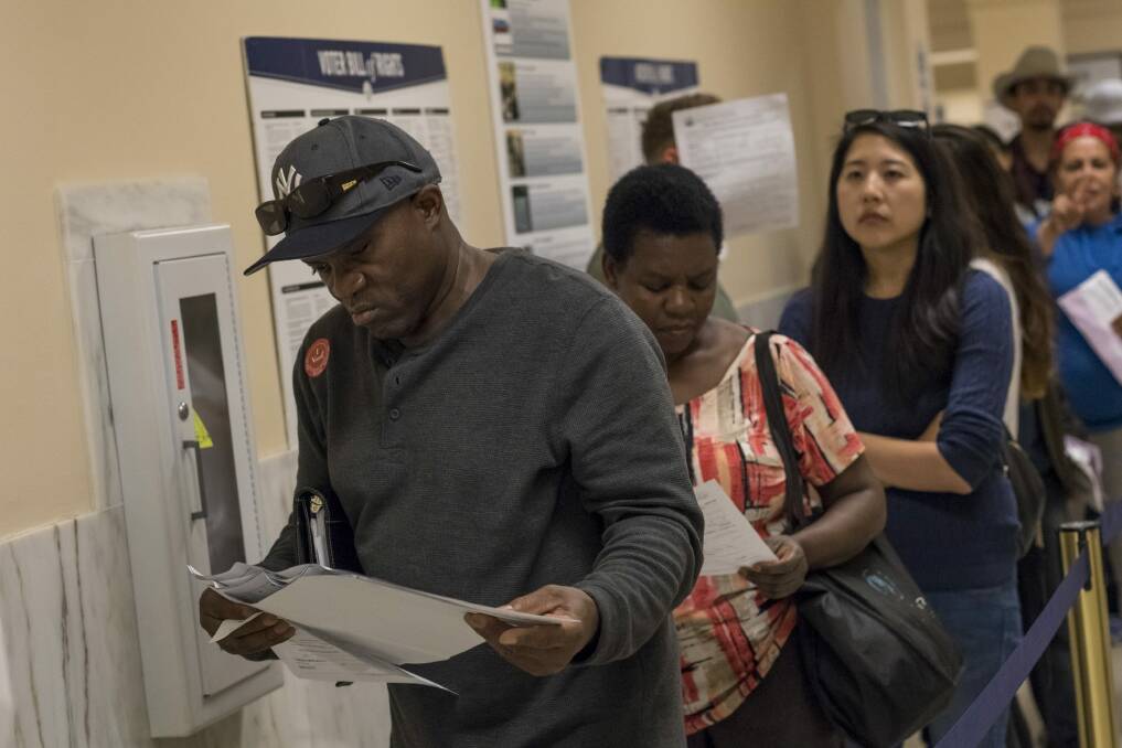 Voters wait in line to cast their ballots in San Francisco. Photo: Bloomberg