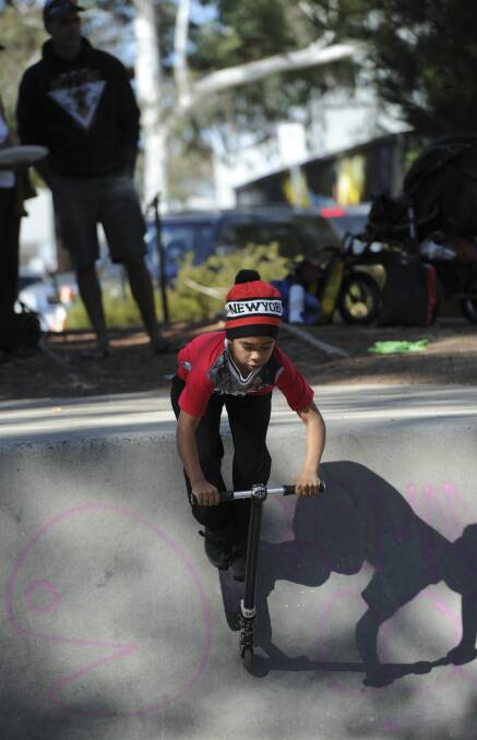 Keedin Cross, 10, of Campbell rides his scooter as part of the festivities. Photo: Graham Tidy
