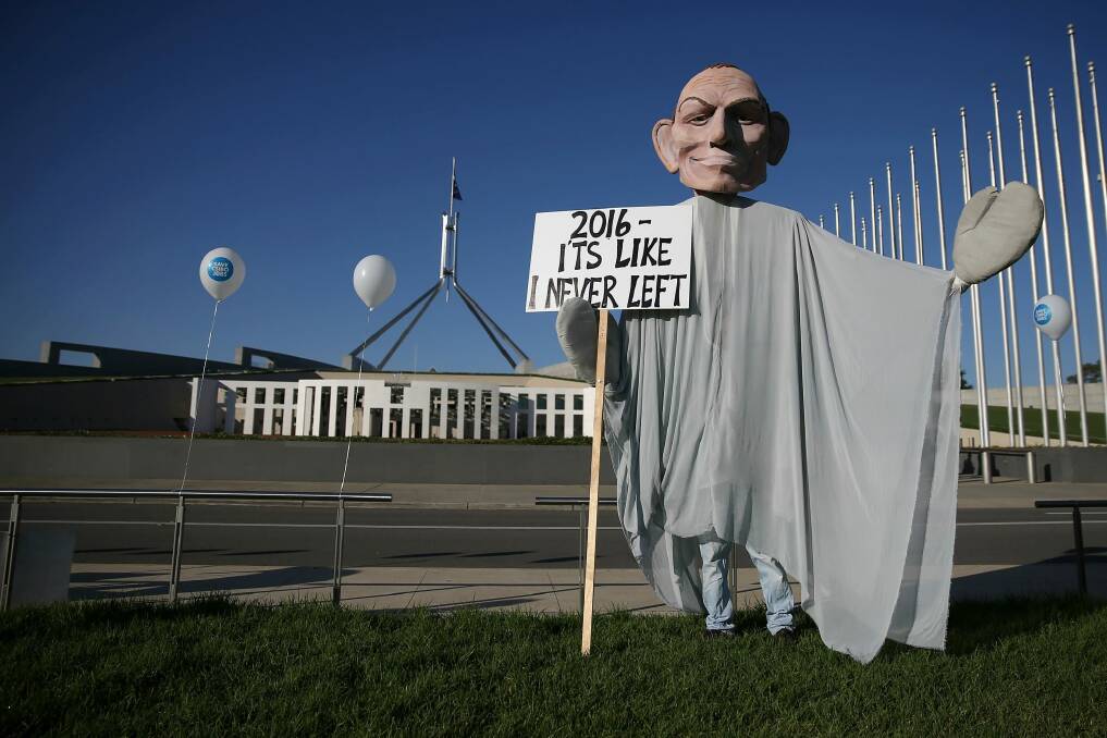 A man in a 'ghost of Tony Abbott' costume at the rally to save CSIRO jobs on the front lawn of Parliament House. Photo: Alex Ellinghausen