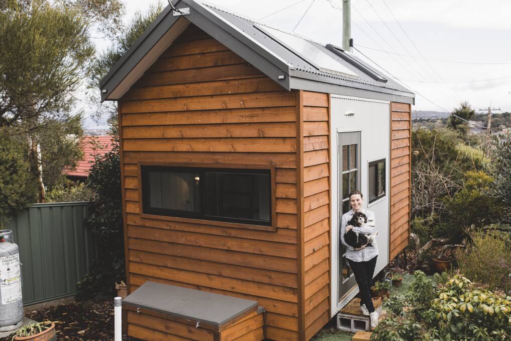 Jessica Conway with her dog Chloe in her Giralang tiny home. Photo: Jamila Toderas
