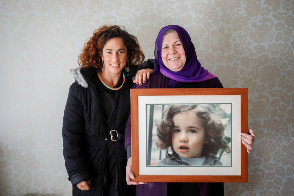 Bianca Elmir with her mother Diana Abdel-Rahman holding photo of her as a child. Photo: Sitthixay Ditthavong
