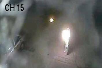 A CCTV image of a person allegedly throwing molotov cocktails at the Gold Curves brothel in Fyshwick on Tuesday May 8. Photo: Supplied by ACT Policing