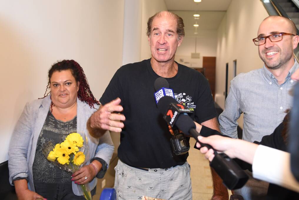 Australian filmmaker James Ricketson (centre), with his daughter Roxanne Holmes (left), arrives at Sydney International Airport. Photo: AAP