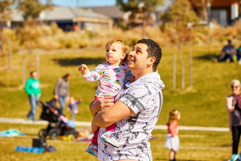 Domenic and Audrey Agresla, of Queanbeyan, watch the kites take to the sky over Googong. Photo: Supplied