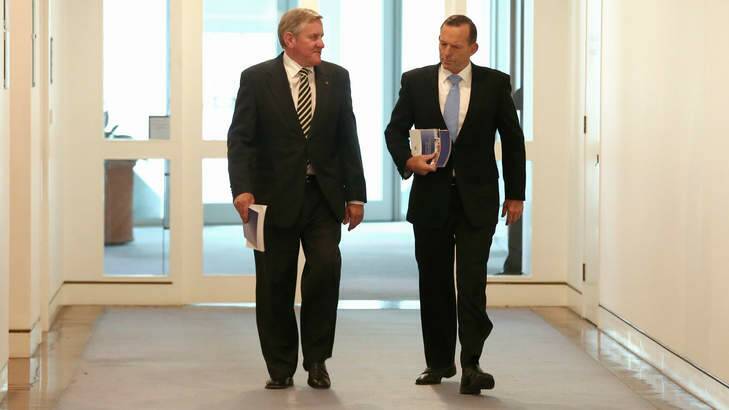 Industry Minister Ian Macfarlane and Prime Minister Tony Abbott arrive for a joint press conference at Parliament House. Photo: Alex Ellinghausen