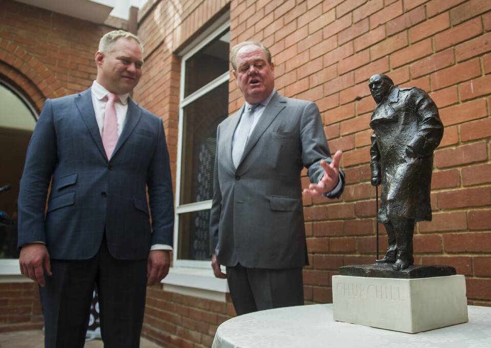 Abode Group general manager Rien Donkin and Sir Winston Churchill's grandson Jeremy Soames with a bronze sculpture of the former UK prime minister, which has been permanently loaned to West Block Hotel owners Geocon. Photo: Elesa Kurtz