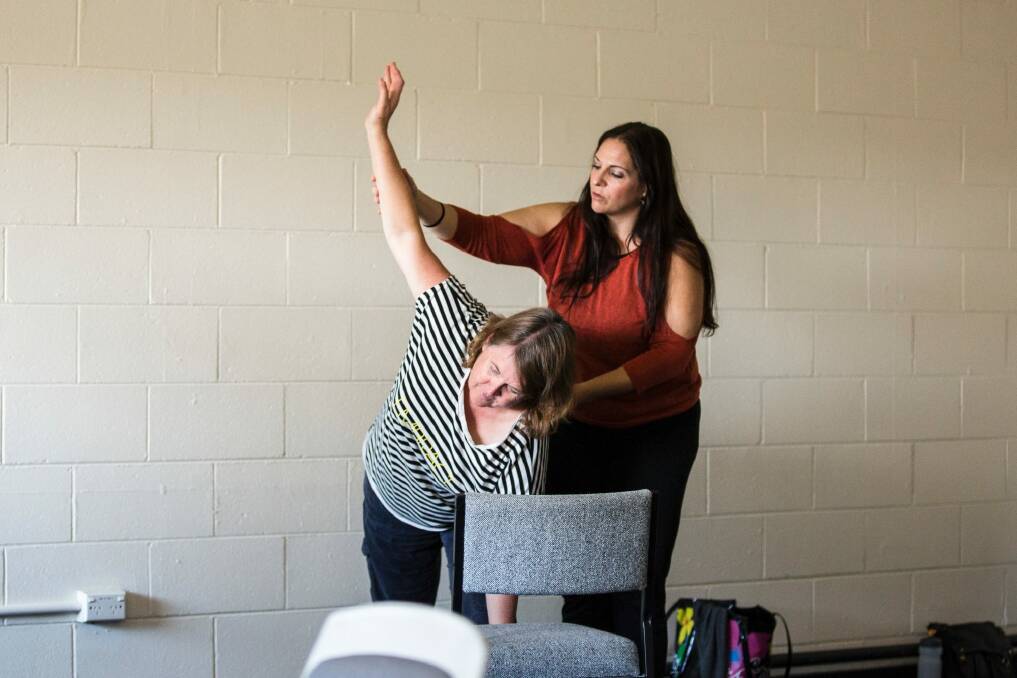 Teacher Eli Haski works with Karen Hardy. Photo: Jamila Toderas