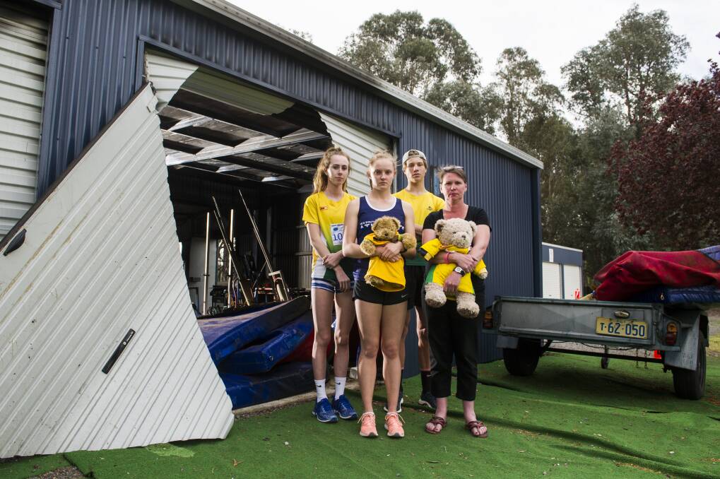 Woden athletics club users Grace Brennan, Caitlin Hanna, Erek Lukowski and Woden Thunder Little Athletics Club Secretary Mel Harding are disappointed to see a shed containing sports equipment at the Woden Athletics Park destroyed due to arson. Photo: Dion Georgopoulos