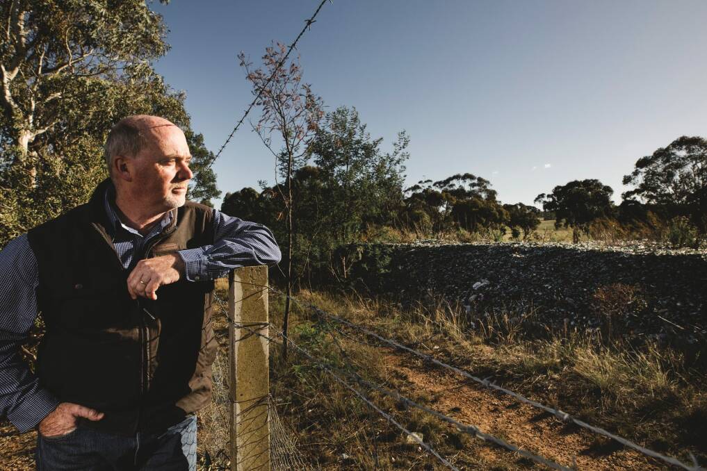 Bywong resident Roger Melton is unhappy about glass that was dumped illegally onto a property 4 years ago by a Canberra contractor.  Photo: Jamila Toderas