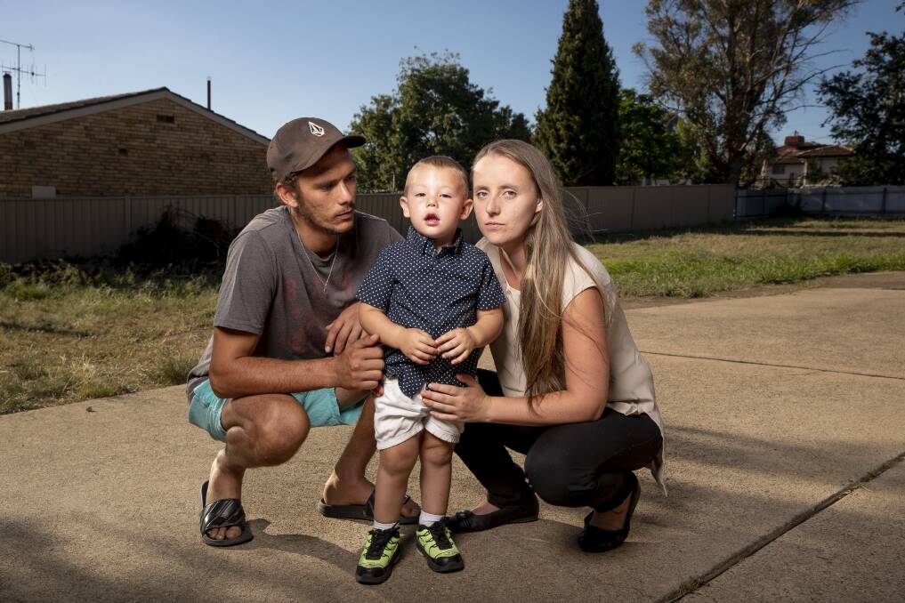 Chris Reynolds (left) and Cassandra Brown-Crane (right) with their two-year-old son Alijah Reynolds the day after he was allegedly left in a bus at a childcare centre.  Photo: Sitthixay Ditthavong