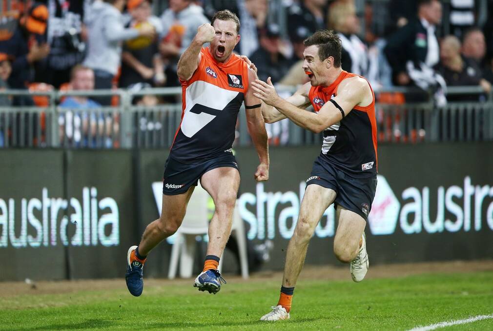 Pumped: Steve Johnson celebrates after kicking the winning goal. Photo: Getty Images