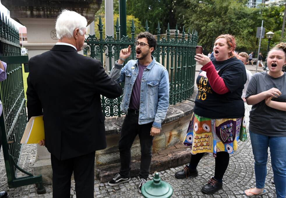 KAP federal leader Bob Katter confronts Socialist Alternative protesters at the gates of Parliament House in Brisbane. Photo: Dan Peled - AAP