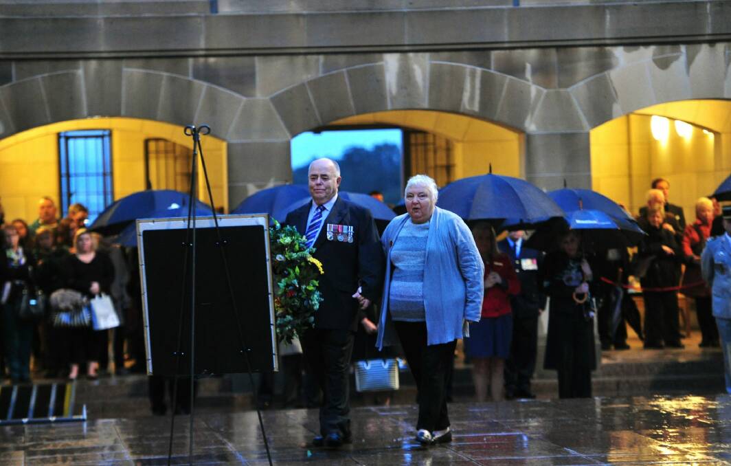 Representing the Bell family are from left, Alan Hall and his wife Laureen both of Melbourne lay a wreath during the Last Post ceremony at the Australian War Memorial in Canberra for Flight Lieutenant John Napier Bell.  Photo: Melissa Adams 