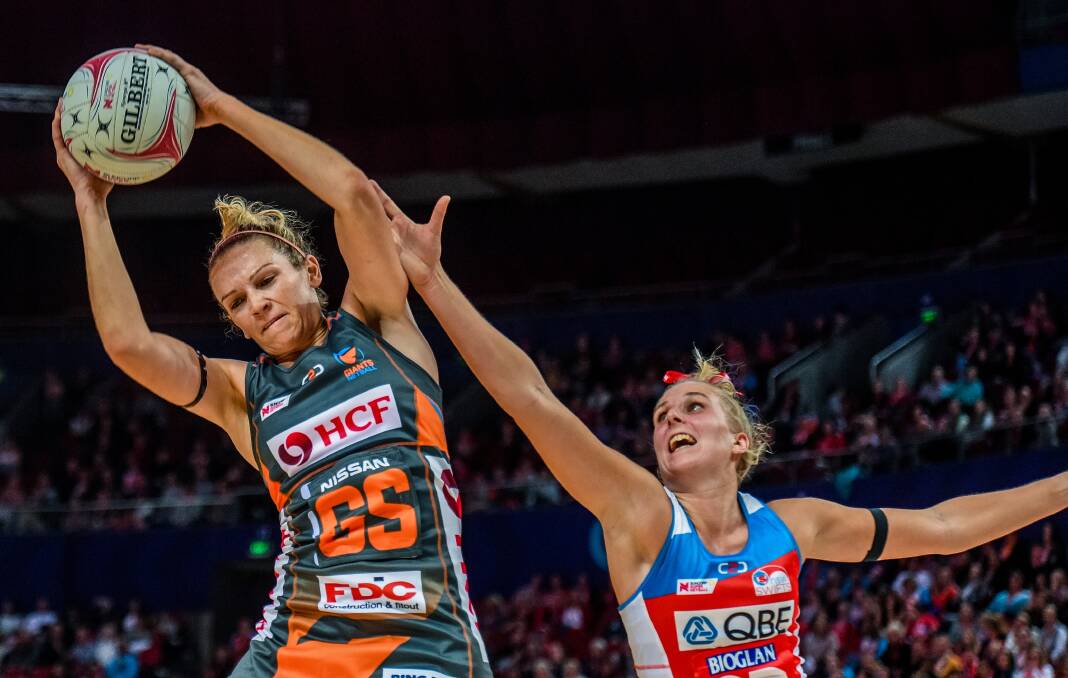 Full stretch: Jo Harten of the Giants competes for possession against Maddy Turner of the Swifts at the Qudos Bank Arena. Photo: AAP