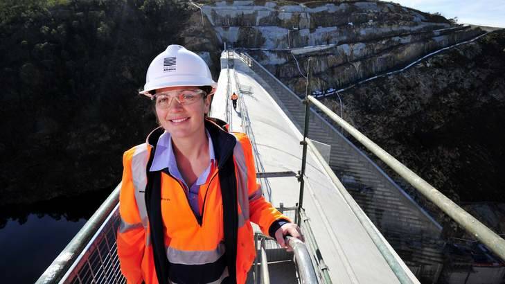 Rachel Clarke stands on top of the Cotter Dam as workers make some final touches before the open day on Sunday. Photo: Jay Cronan