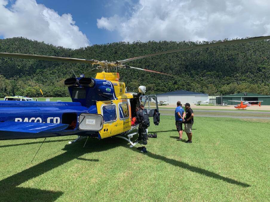 A skydiving instructor and tourist have been winched from thick bushland on a mountain after their skydive went awry. Photo: RACQ CQ Rescue