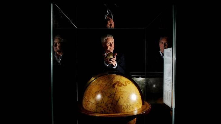 The curator of maps at the National Library of Australia, Martin Woods, with some rare globes. Photo: Colleen Petch