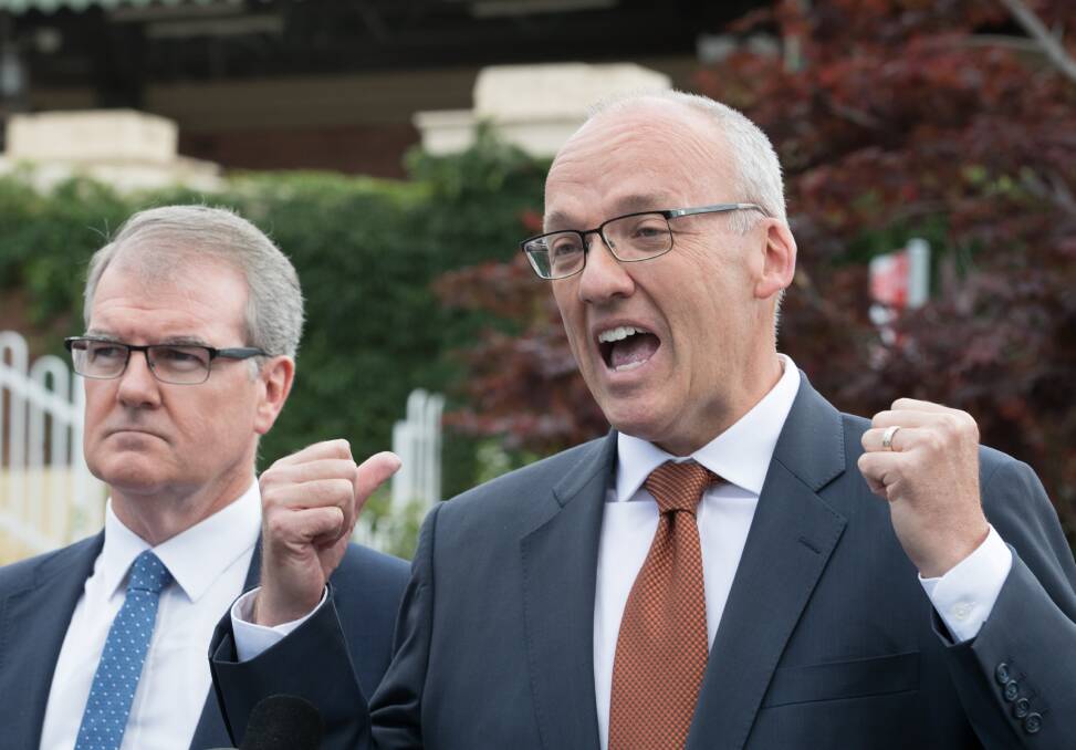 Luke Foley, flanked by Michael Daley, making a transport policy announcement on Thursday morning, before resigning in the evening. Photo: Janie Barrett