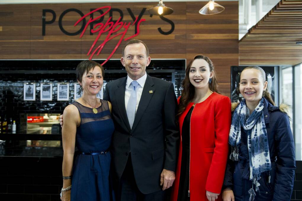 The opening of Poppy's cafe at the Australian War Memorial. Trooper David Pearce's daughters Hannah and Stephanie (red), widow Nicole Pearce with Prime Minister Tony Abbott. Photo: Jay Cronan