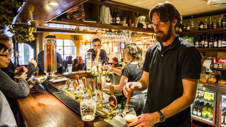 Jeremy Michael serves a beer at the Wig and Pen at Canberra House. Photo: Rohan Thomson