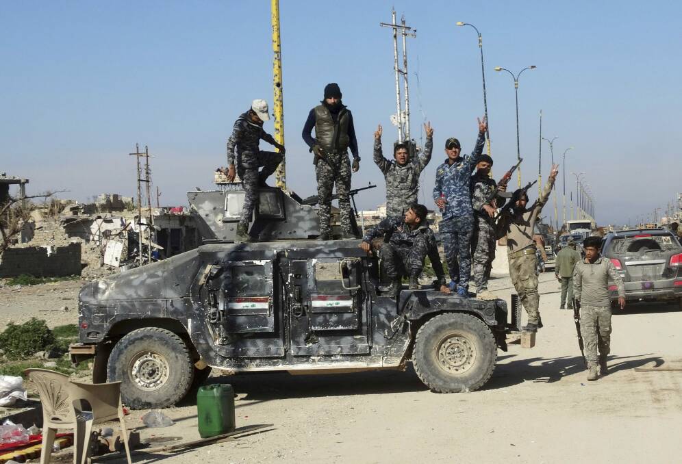 Iraqi security forces, celebrate after regaining control of the town of Husaybah, eight kilometres east of Ramadi, Iraq, after heavy clashes with Islamic State fighters.