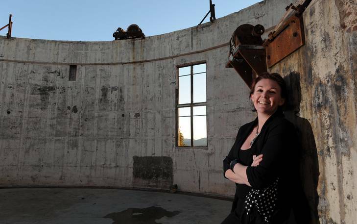 The Director of Scope Mount Stromlo, Simone Hunter, in the burnt out building shell. She will be organising an exhibition of memorabilia from the 2003 bushfires, for the Centenary of Canberra celebrations. Photo: Graham Tidy