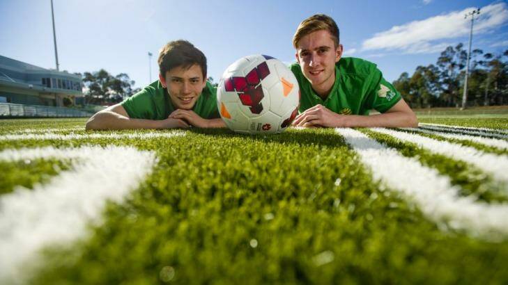 Soccer players Joe Caletti and Jackson Bandiera check out the new synthetic soccer pitch at the AIS that will be used in the Canberra National Premier League this weekend.  Photo: Jay Cronan