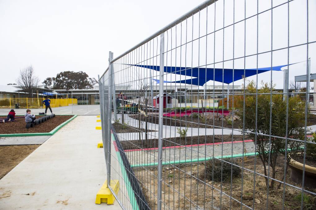 Temporary fencing was erected around garden beds in the preschool area at Harrison School on Thursday. It is unclear whether this is one of the areas that contains non-friable asbestos. Photo: Dion Georgopoulos