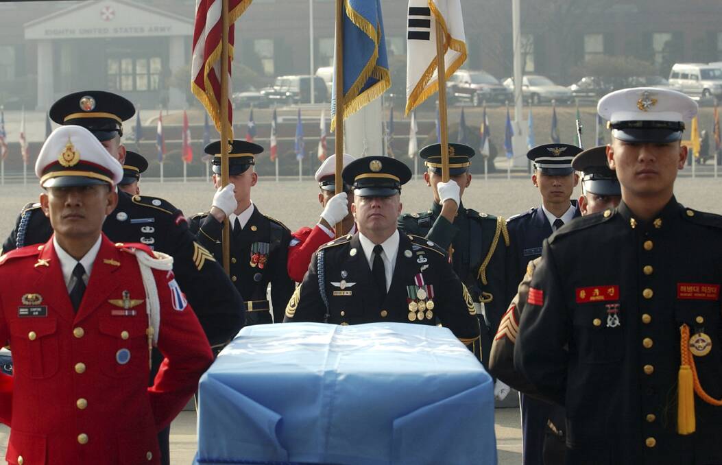 United Nations Command soldiers stand around the coffin during an honor guard departure ceremony in South Korea. One outcome of the summit between President Donald Trump and North Korean leader Kim Jong Un was the commitment to recover the remains of US military personnel missing-in-action from the Korean War. Photo: AP/Yun Jai-hyoung