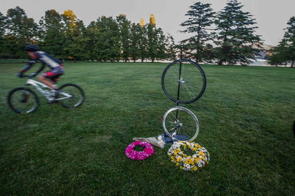 A cyclist passes the memorial to British endurance cyclist Mike Hall in Nara Park, where a memorial was held early Friday morning. Photo: Karleen Minney.