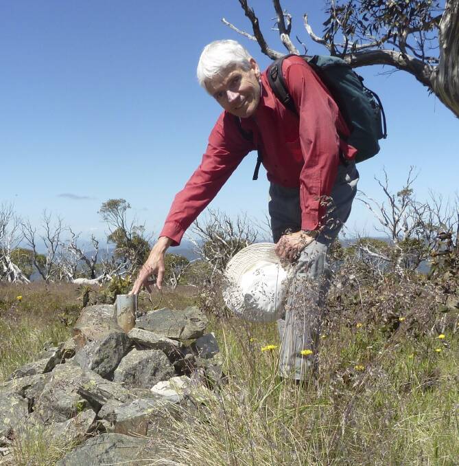 Historian Matthew Higgins at a survey mark installed in the Brindabellas in 1914 by surveyor Harry Mouat. Photo: Tim the Yowie Man
