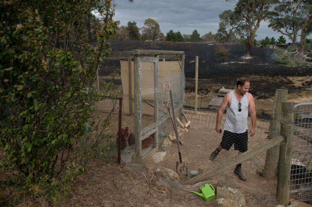 Gerhard Fischer inspects the aftermath of a fast moving bush fire at Widgiewa Rd on Captains Flat Road near Queanbeyan NSW.  Photo: Jay Cronan