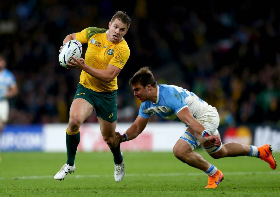 Drew Mitchell breaks the challenge of Lucas Gonzalez Amorosino of Argentina on the way to setting up Adam Ashley-Cooper to score Australia's fourth try of the game during the 2015 Rugby World Cup semi-final. Photo: Getty Images