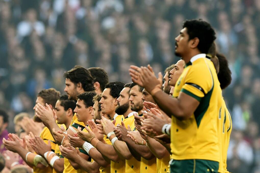 The Wallabies join in the applause in memory of Australian Test cricketer Phillip Hughes. Photo: Getty Images