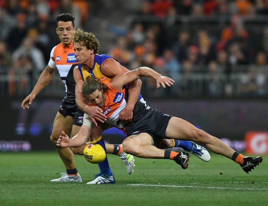 West Coast's Matt Priddis and the Giants' Callan Ward fly for the ball. Photo: AAP