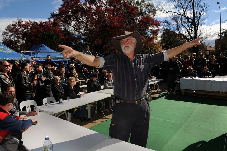 The ringer, Roland Trebesius, calls bets at the two-up game at the Canberra Services Club in Manuka following the ANZAC Day march yesterday. Photo: Richard Briggs