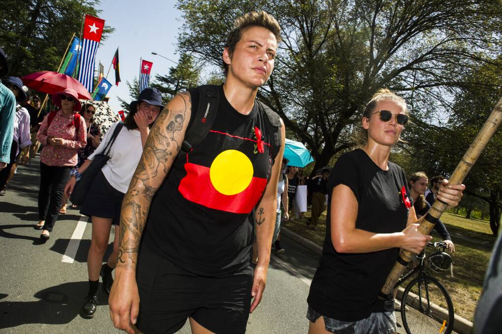 Invasion Day protesters march through Canberra on their way to the Aboriginal Tent Embassy on Saturday morning. Photo: Dion Georgopoulos